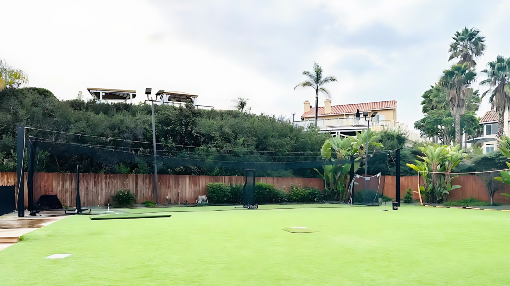 A full length backyard batting cage with Turf as its surface.