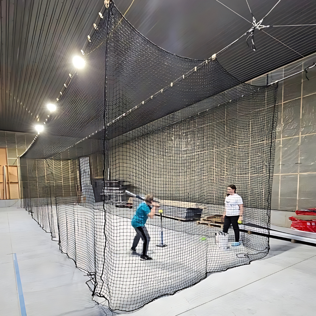 A properly installed batting cage net in an indoor facilty